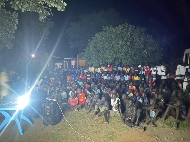 Villagers gathered at dusk for a Jesus Film screening