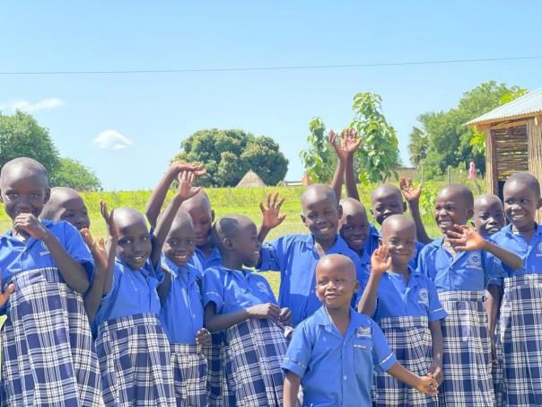 Children waving in school uniforms